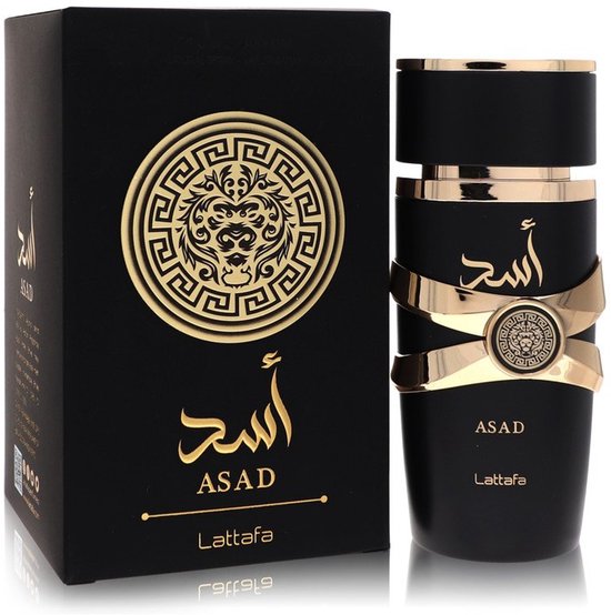 Boîte et flacon noirs avec des détails dorés. Le flacon présente une bande dorée et le texte 'ASAD' en lettres arabes dorées.