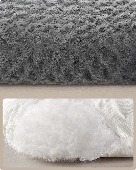 Donkergrijs pluche hondenbed met geborduurde bloemmotieven en witte vulling.