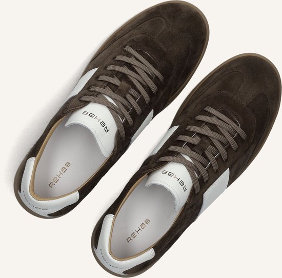 Bovenaanzicht van bruine suède sneakers met witte strepen, witte veters en witte voering.