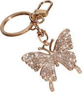 Gouden sleutelhanger met vlinderhanger bezet met strass.