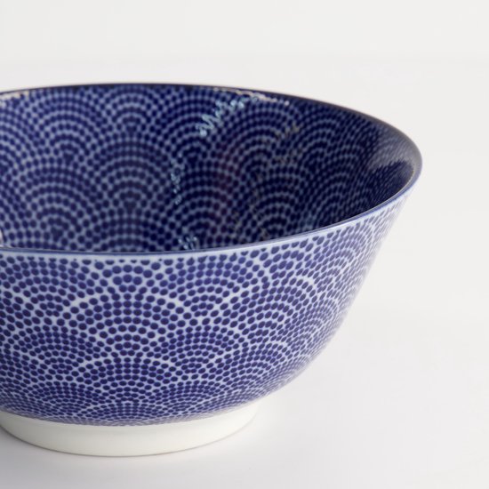 Detail van een blauwe kom met wit 'wolken' patroon.