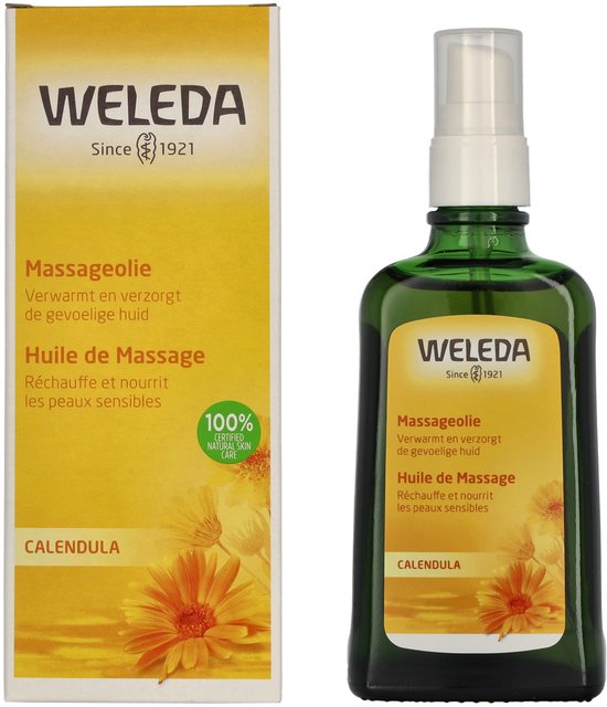 Gele verpakking naast een groene glazen fles met Weleda massageolie. Op de verpakking 'Massageolie' en 'Calendula'.