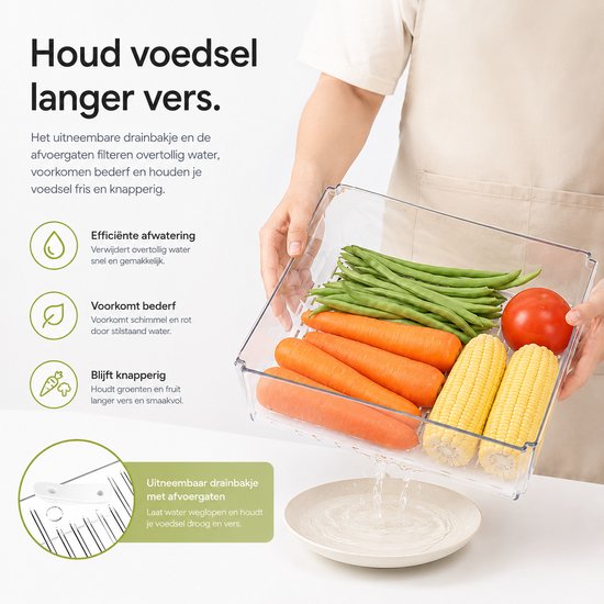 Een hand toont een BOTC organizer met groenten, waarbij water uit het uitneembare drainagemandje loopt.