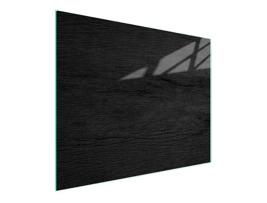 Planche à découper en bois noir avec un bord vert et une ombre de feuilles.