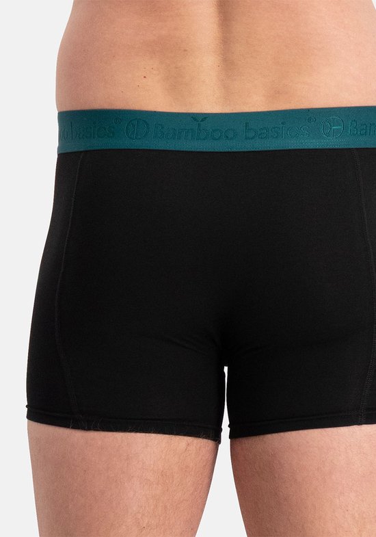 Boxer Bamboo Basics noir porté par un mannequin, avec une ceinture élastique bleu-vert.