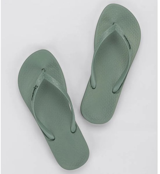 Lichtgroene Ipanema teenslippers met golvend patroon op de zool en merknaam.