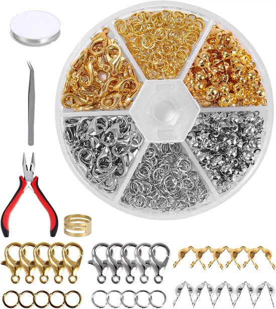 Set met gouden en zilveren ringen, karabijnsluitingen, tangen en draad voor het maken van sieraden.