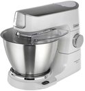 Robot pâtissier Kenwood blanc avec bol inox et couvercle anti-éclaboussures.