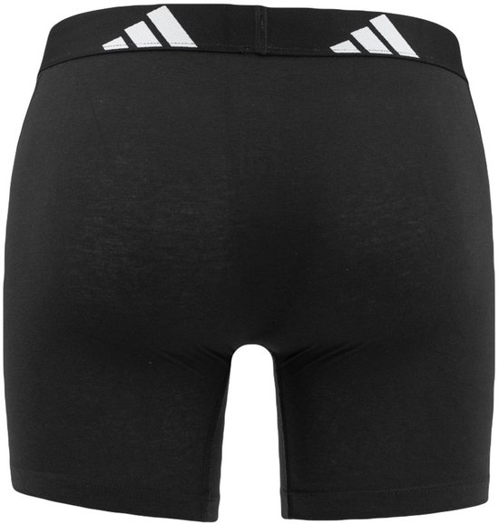Zijzicht van zwarte Adidas boxer briefs met witte Adidas logo's op de zwarte tailleband.