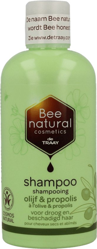 Lichtgroene fles shampoo van Bee Honest, met een honingraatlogo. Het label vermeldt "shampoo olijf & propolis voor droog en beschadigd haar".