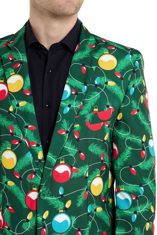 Detail van groen colbert met kerstopdruk. Zichtbaar zijn de revers en de knopen.
