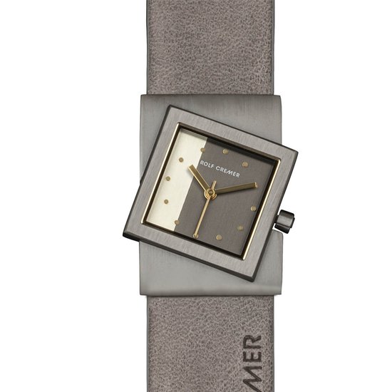 Grijze leren band met ROLF CREMER opdruk, om een vierkant horloge met een grijs en wit vlak, gouden wijzers en gouden stippen.