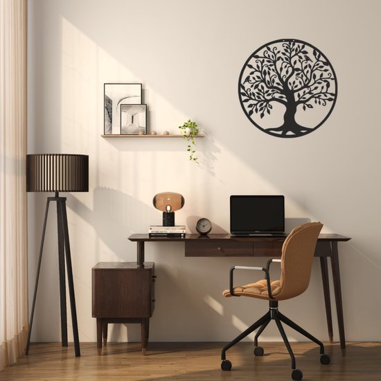 L'arbre de vie en métal noir est suspendu à un mur au-dessus d'un bureau avec un ordinateur portable et une chaise de bureau.