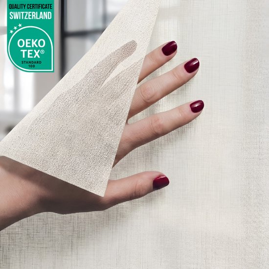 Een hand met bordeauxrode nagellak strijkt over een lichte, textielachtige raamfolie met een subtiel weefpatroon. OEKO-TEX® gecertificeerd.