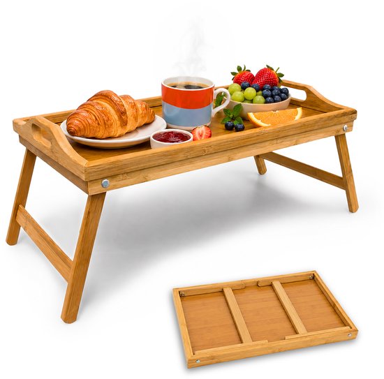 Ontbijt op bed dienblad met een croissant, jam, koffie en fruit op een bamboe dienblad met inklapbare poten.