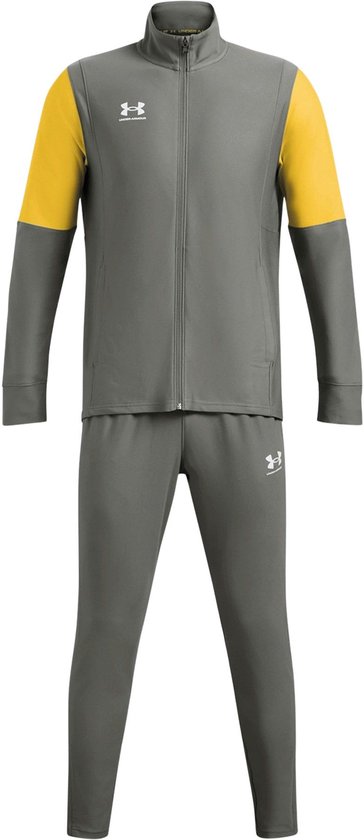Grijs Under Armour trainingspak met gele accenten op de mouwen en wit Under Armour-logo op jas en broek.