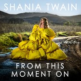 Shania Twain draagt een volumineuze gele baljurk op een modderig pad met de tekst 'From This Moment On'.