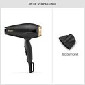 Zwarte BaByliss föhn met gouden accenten en een afneembare blaasmond in de verpakking.