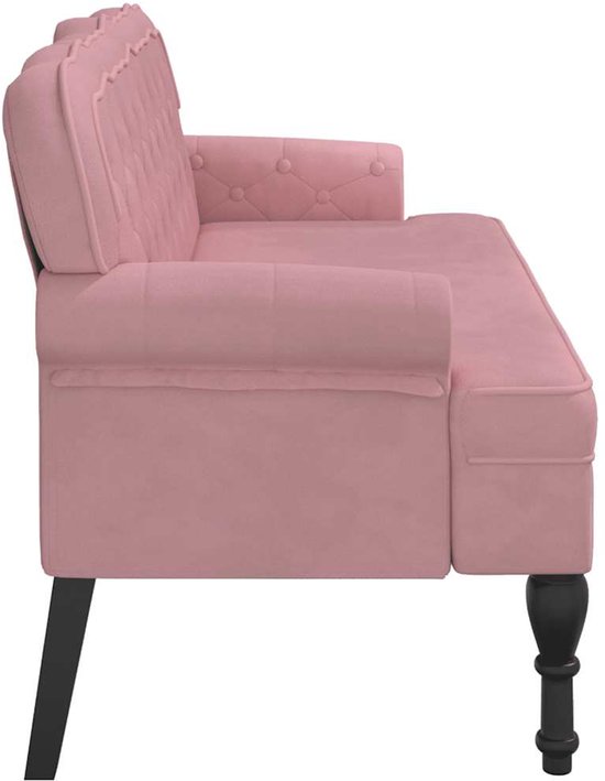 Roze fluwelen bankje met gecapitonneerde rugleuning en zwarte houten poten.