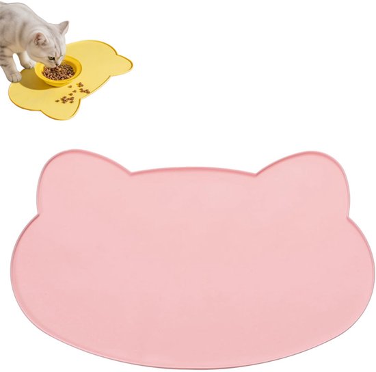 Roze pootvormige placemat. Kleine kat eet uit een gele voerbak.