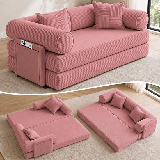 Roze ribfluwelen slaapbank met corduroy stof, twee ronde kussens aan de zijkant en twee vierkante rugkussens.