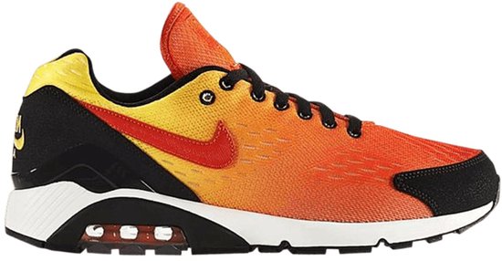Zijaanzicht van Nike Air 180 sneaker in oranje en geel met zwarte veters en een zichtbare Air-unit.