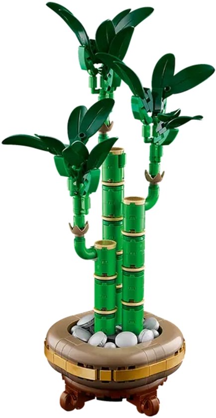 Plante de bambou LEGO verte dans un pot doré avec des pierres, sur fond blanc.