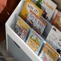 Boekenkast met kinderenboeken zoals 'Fly Guy Presents Firefighters' en 'May I Please Have a Cookie?'.