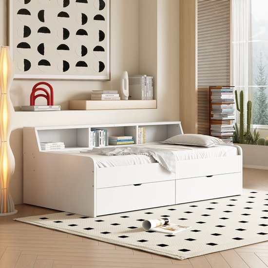 Wit slaapbank met twee lades en opbergvakken, opgemaakt in een kamer met sprei.