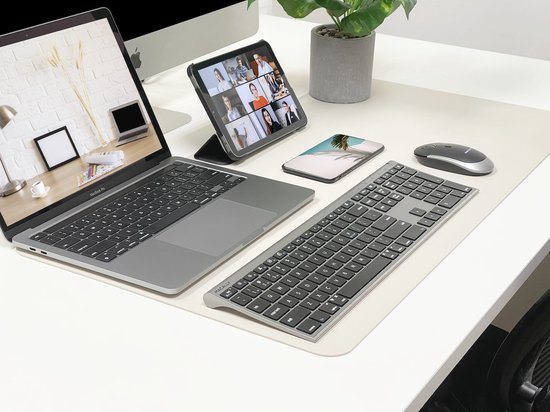 Een bureau met een MacBook, Macally toetsenbord en muis, iPad en telefoon.