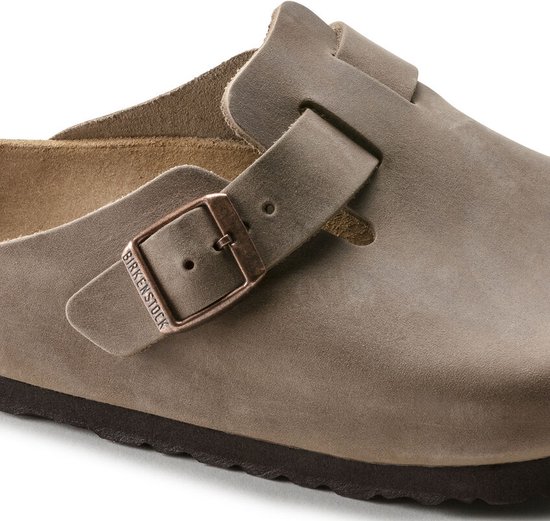 Sluiting van een bruine Birkenstock Boston klomp met gesp en logo.