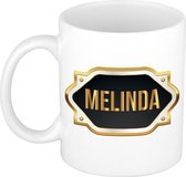 Melinda naam cadeau mok / beker met gouden embleem - kado verjaardag/ moeder/ pensioen/ geslaagd/ bedankt