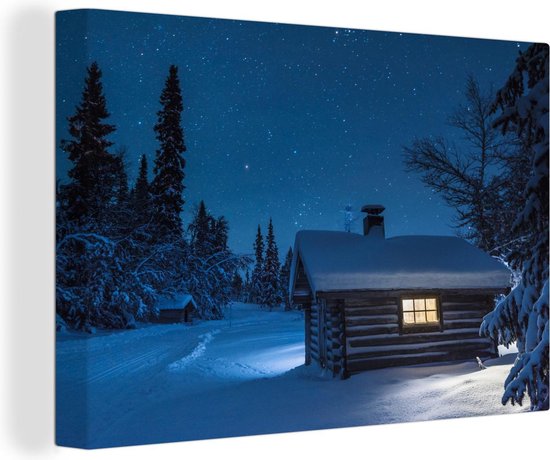 Canvas Schilderij Een verlichte blokhut in een donkere winter - 60x40 cm - Wanddecoratie