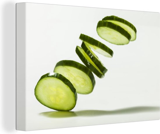 Canvas Schilderij Afbeelding van plakjes komkommer met schaduw op de achtergrond - 60x40 cm - Wanddecoratie