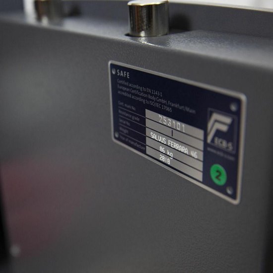 Close-up van een certificeringslabel op een grijze kluis met tekst 'SALVUS FERRARA 46'.