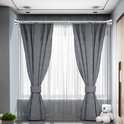 Zilverkleurige gordijnroede met twee grijze gordijnen erlangs gehangen.