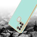 Mintgroen telefoonhoesje met gouden rand, vallend op gebarsten ondergrond.