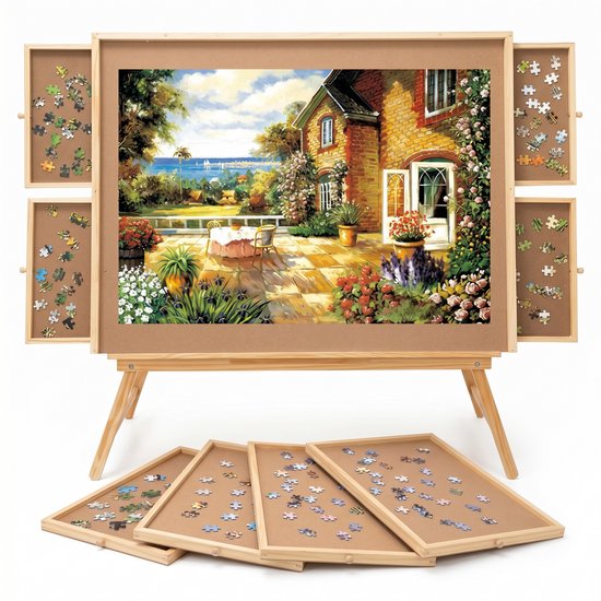 Table à puzzles avec tiroirs coulissants, représentant une maison au bord de la mer.