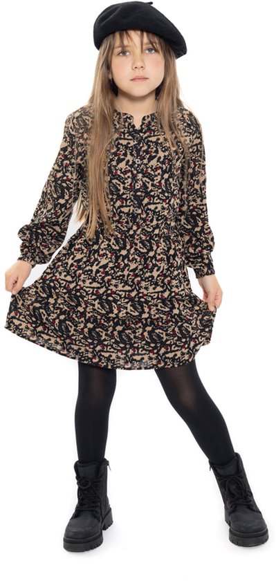 Meisje in beige, zwart en rode jurk met abstracte print. Zwarte baret, panty en laarzen.