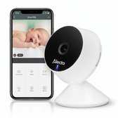 Witte Alecto babyfoon met een zwarte ronde camera en standaard. Naast de camera is een smartphone met de "Smartlife" app te zien waarop een baby lacht.