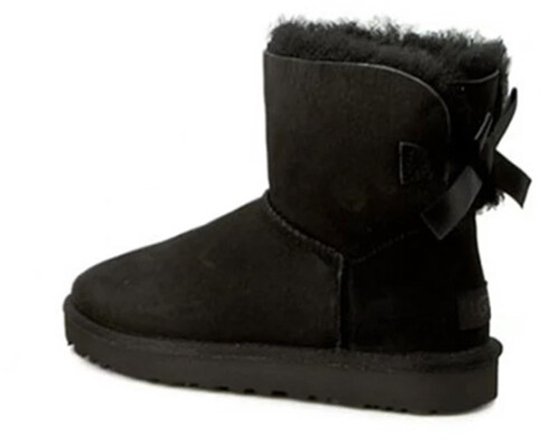 Zwarte UGG enkellaars met strik en schapenvacht voering.