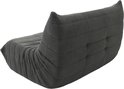 Grijze vloersofa met zachte bekleding, bekeken vanaf de achterkant op witte achtergrond.
