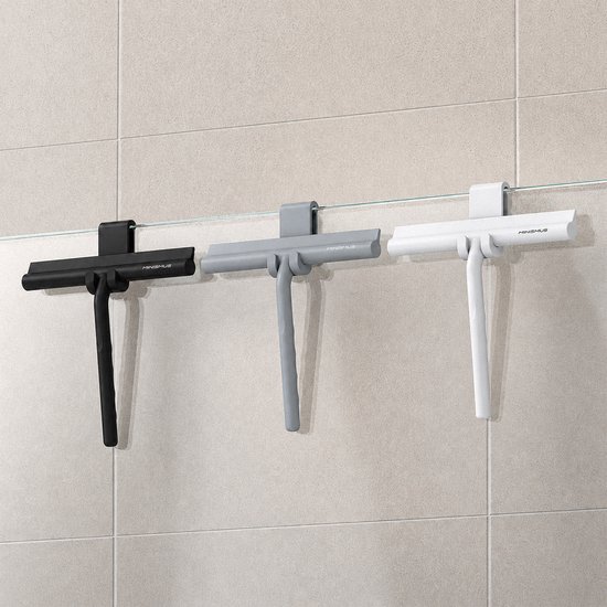 Trois raclettes de douche Minismus en noir, gris et blanc, suspendues à une paroi en verre.