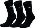 Drie zwarte PUMA sportsokken met wit logo.
