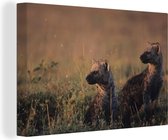 Canvas Schilderij Jonge hyena's op de savanne - 30x20 cm - Wanddecoratie