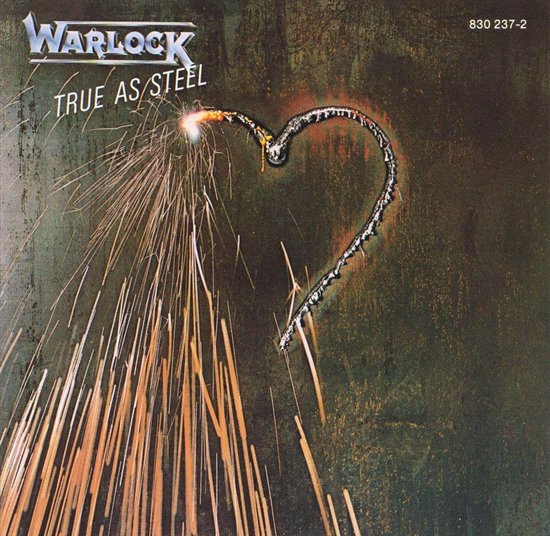 Albumhoes met de titel "Warlock TRUE AS STEEL". Een hart van gloeiend metaal wordt uitgesneden met vonken.