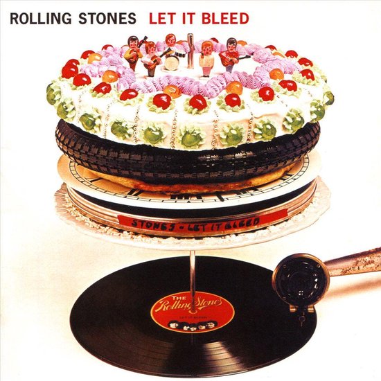 Rolling Stones Let It Bleed albumhoes: een taart versierd met bandleden-figuurtjes,kersen en slagroom, op een autoband en platen.