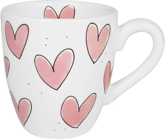 Tasse blanche avec un imprimé de cœurs roses et de points, vue de côté avec une anse.