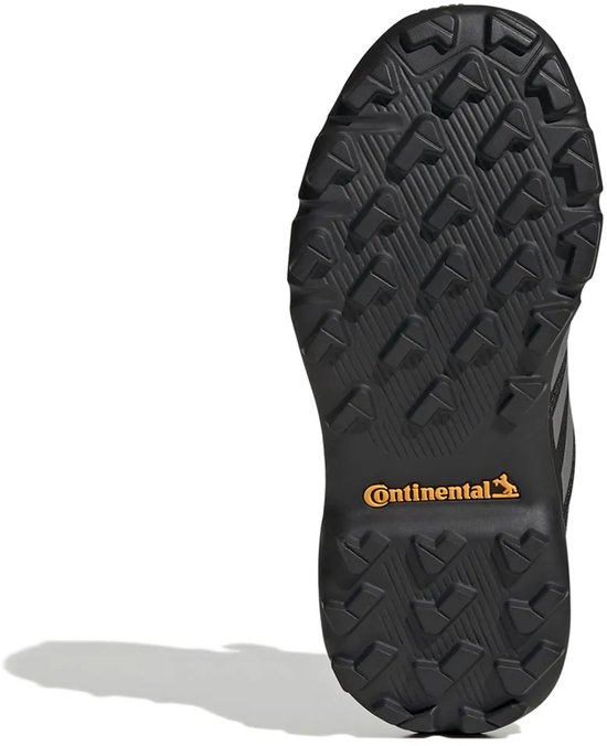 Zool van zwarte kinderschoen met Continental-profiel en oranje logo.