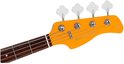 Kop van een oranje elektrische basgitaar met 'Marcus Miller' logo en vier stemmechanieken.